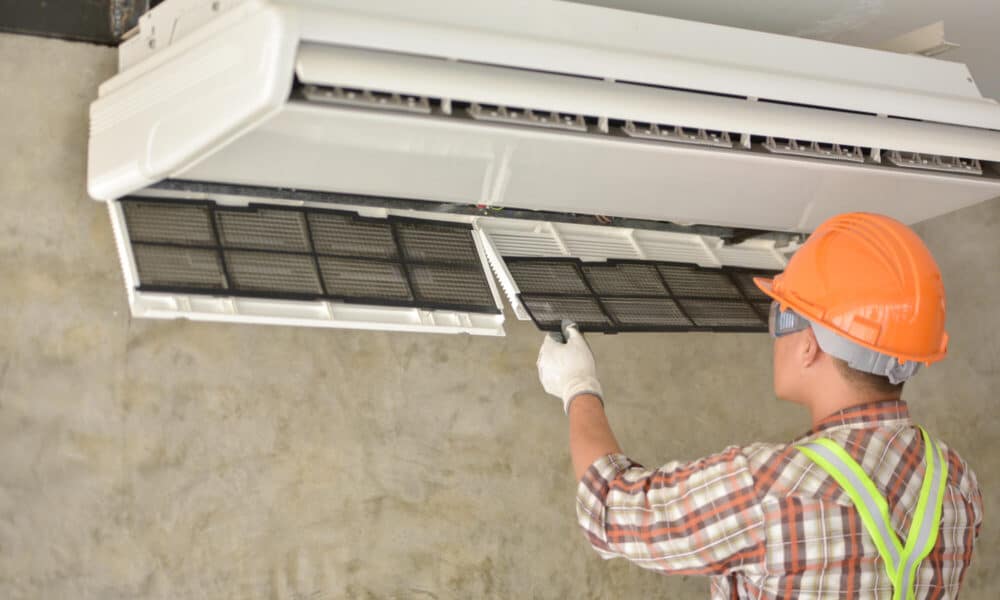 a-young-technician-changing-hvac-air-conditioner-filter